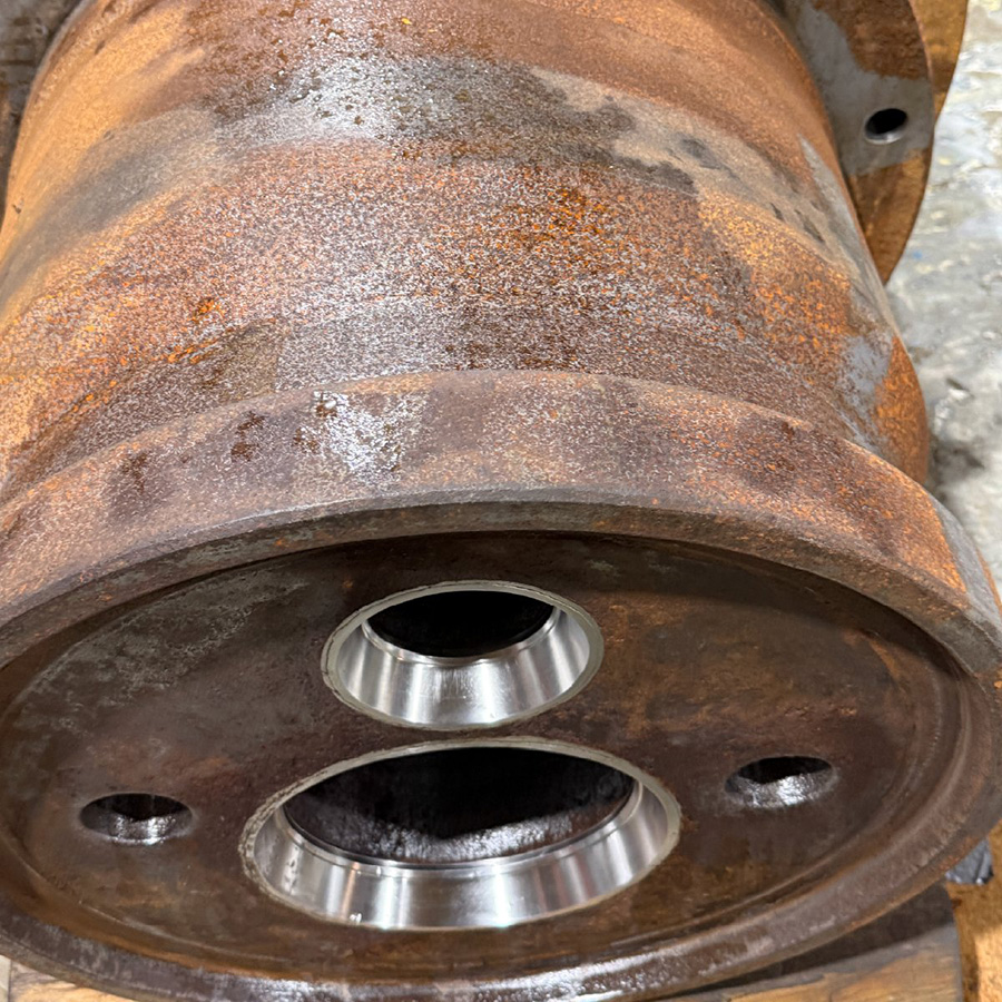 dirty, rusty machine part with old coatings still attached